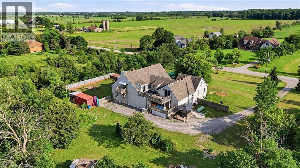 Expansive property with a multi-level structure featuring light grey siding and a brown shingled roof - 97 Smith Road, Hamilton, ON
