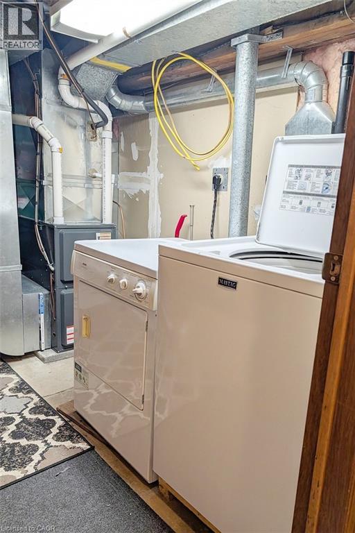 Dedicated laundry area featuring a white top-load washing machine and a white electric dryer - 98 Kipling Road Unit# 2, Hamilton, ON