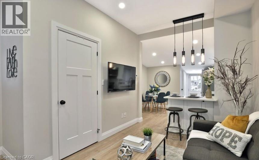 Open-concept living space with wood-finish flooring - 33 Hawthorne Avenue, Hamilton, ON