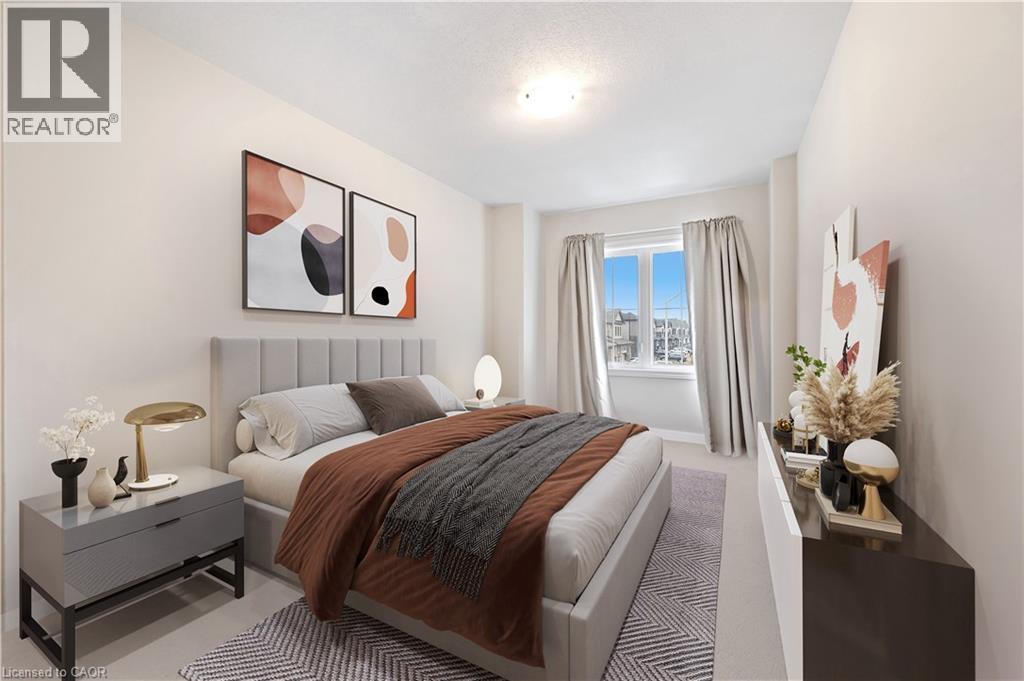 Bright bedroom featuring a large window, neutral wall paint, overhead lighting, and soft carpet flooring - 61 Vanilla Trail, Thorold, ON