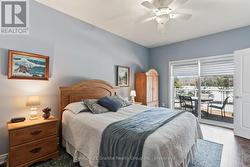 Primary bedroom w/ walkout to lakeside deck -