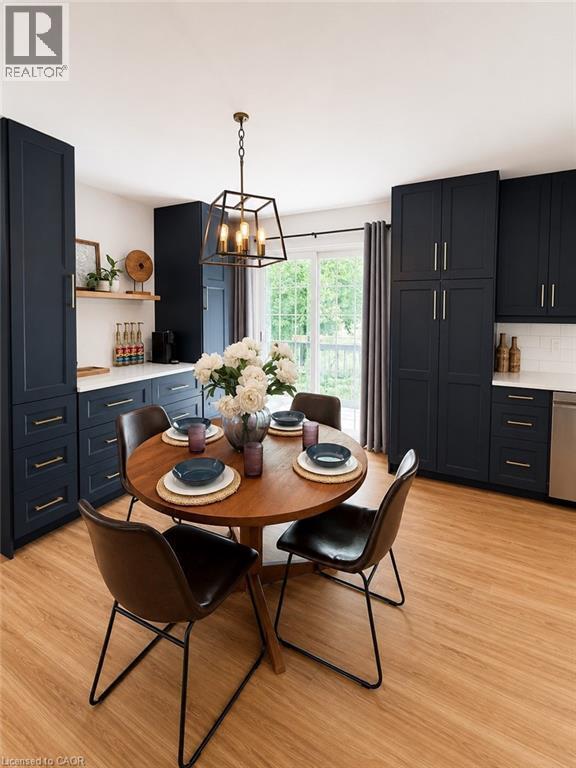 Kitchen featuring full-height navy cabinetry with brass hardware, white countertops, and wood-finish flooring - 355 East 36Th Street, Hamilton, ON