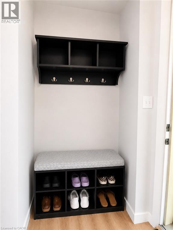 Built-in entryway organization featuring black shelving with storage cubbies and coat hooks - 355 East 36Th Street, Hamilton, ON