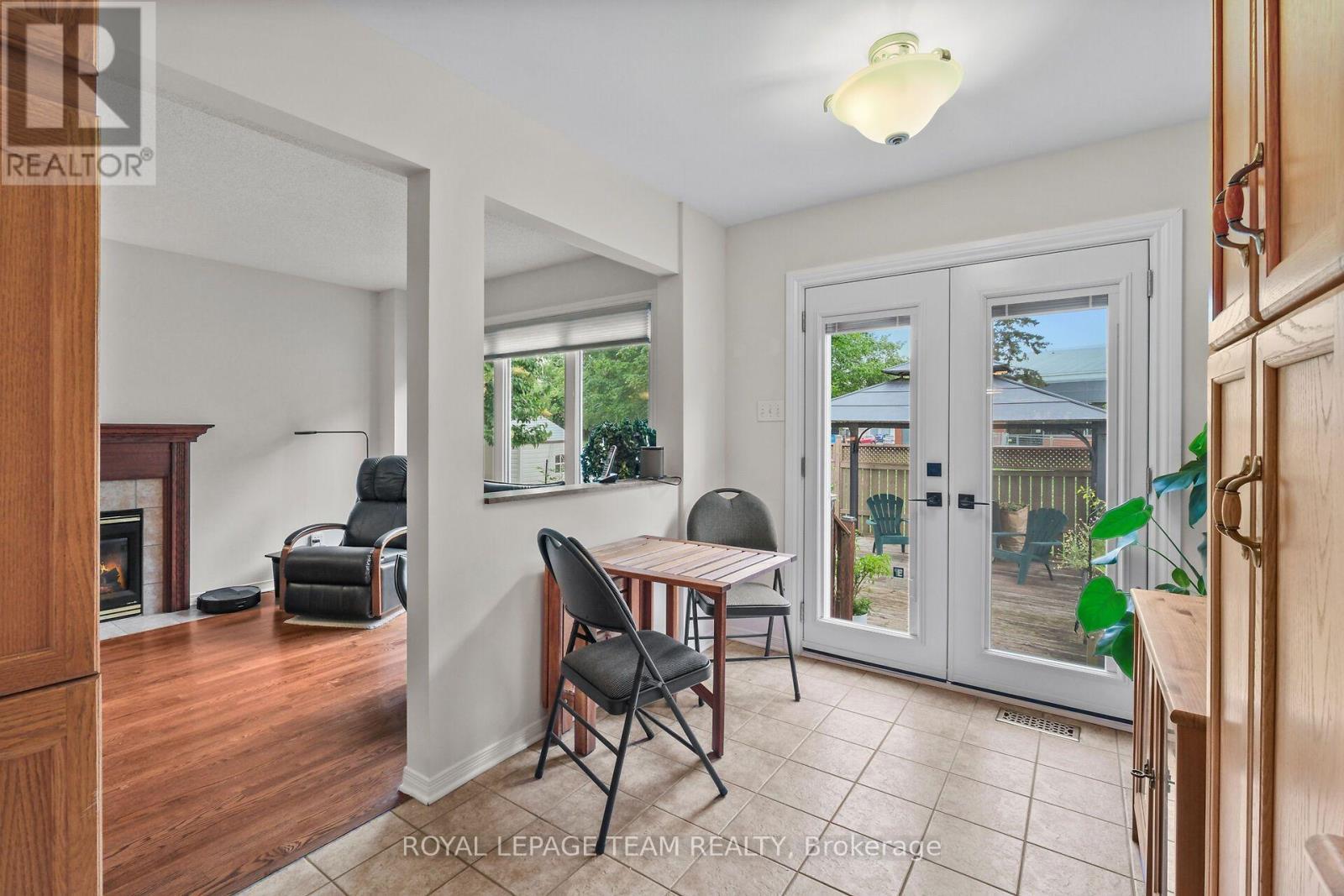 Patio doors in breakfast area lead to rear deck. - 70 College Circle, Ottawa, ON