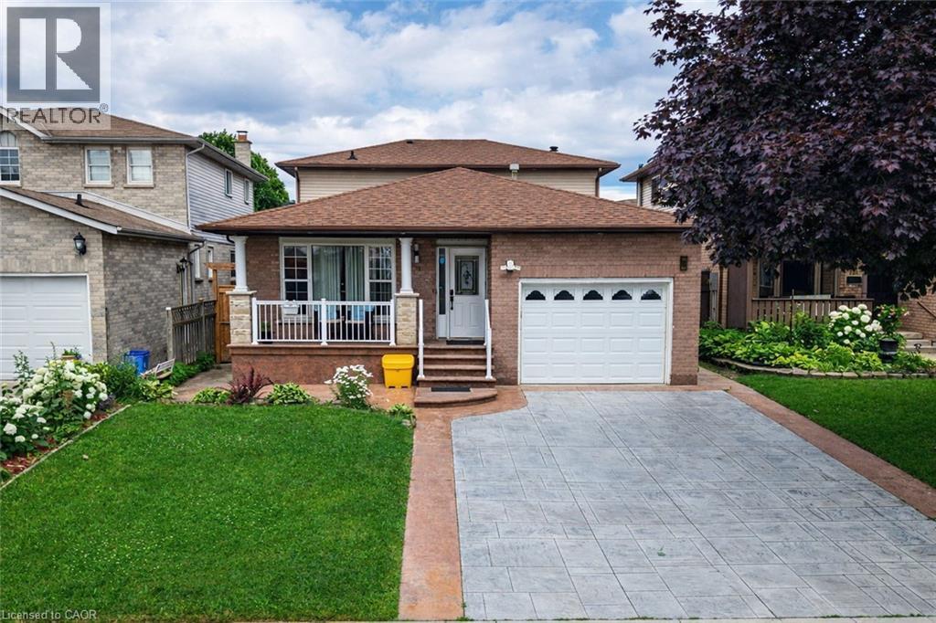 Brick exterior with an attached single-car garage and a paved driveway - 214 Merrilee Crescent, Hamilton, ON