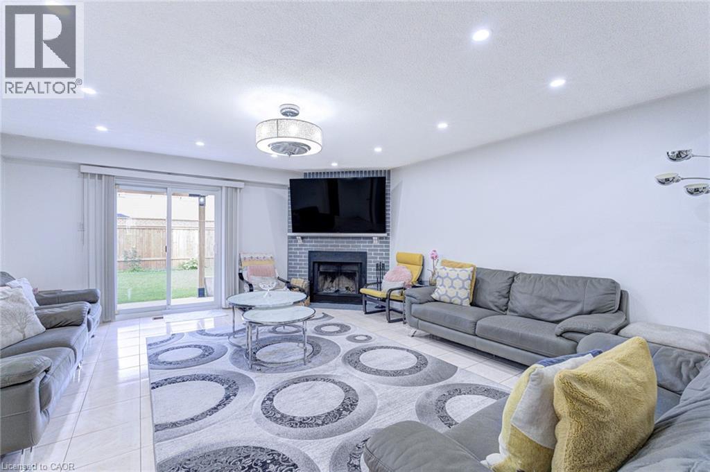 Spacious living area featuring polished tile flooring and recessed lighting - 214 Merrilee Crescent, Hamilton, ON