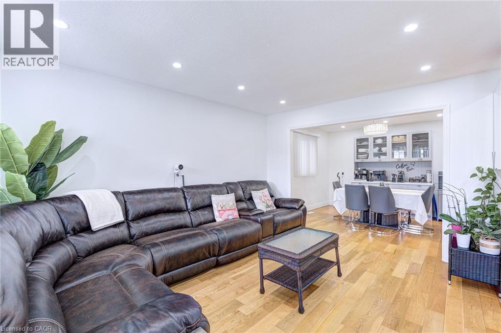 Open living area featuring light wood-finish flooring, recessed lighting, and a wide entryway - 214 Merrilee Crescent, Hamilton, ON