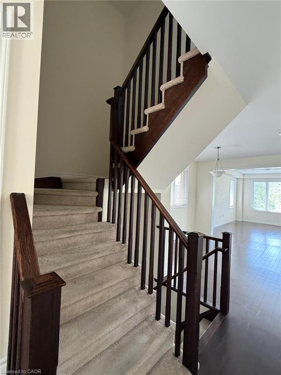 Carpeted staircase with dark wood-finish handrails and balusters - 63 Ridge Road Unit# Upper, Cambridge, ON