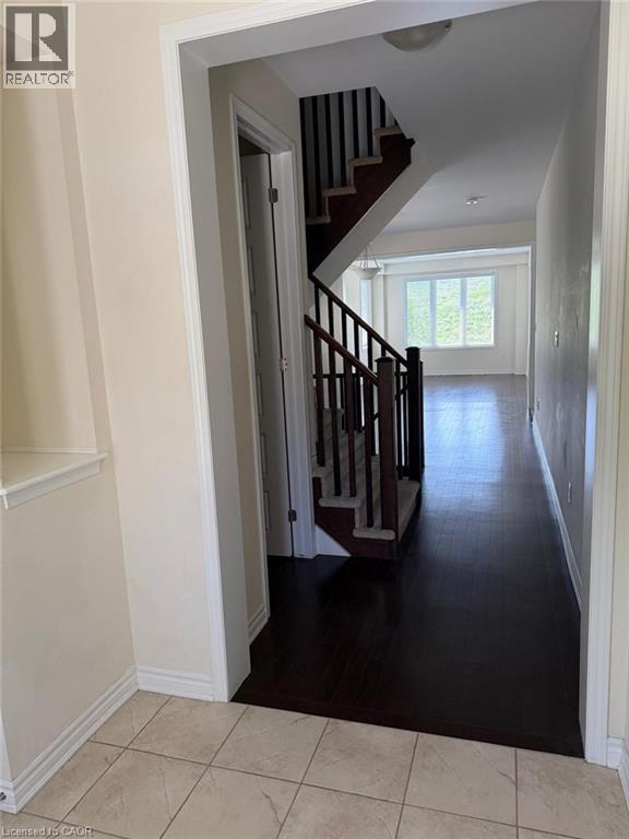Open concept entryway with tile flooring transitioning to dark wood-finish flooring - 63 Ridge Road Unit# Upper, Cambridge, ON