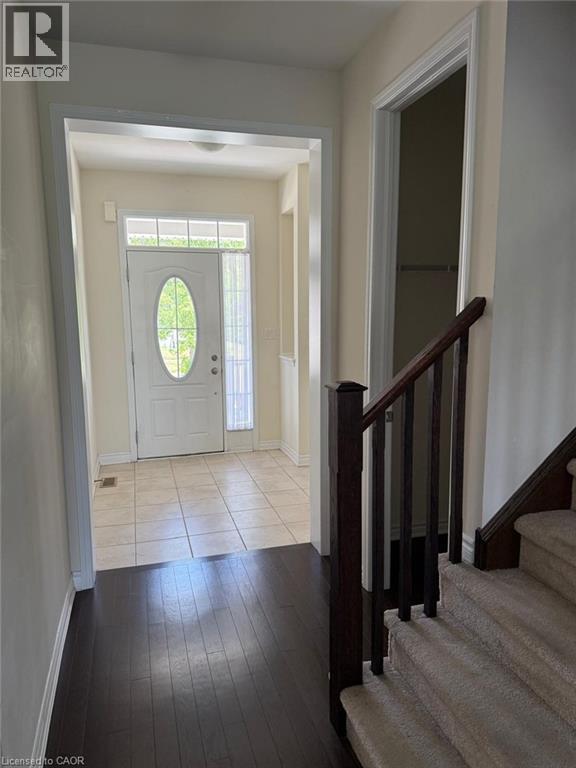 Entryway featuring a white paneled door with an oval glass insert and transom window - 63 Ridge Road Unit# Upper, Cambridge, ON
