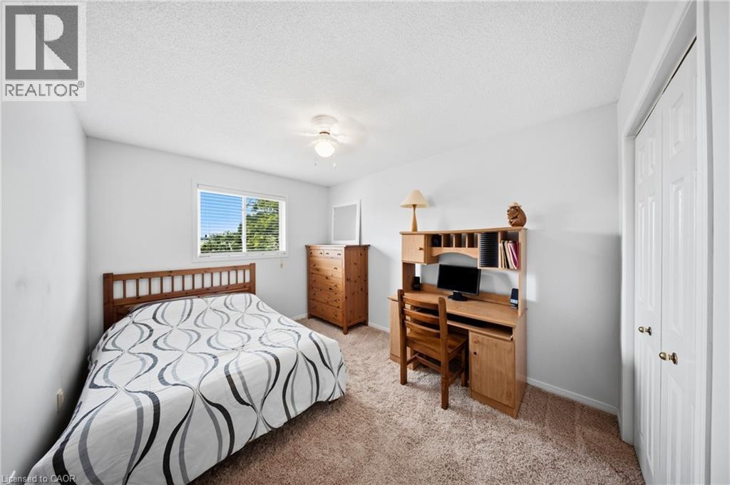 Carpeted room with a window featuring horizontal blinds, white walls, and a ceiling fan with integrated lighting - 16 Scottacres Boulevard, Caledonia, ON
