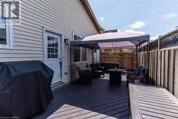 Dark wood-finish deck featuring a covered gazebo area - 