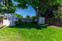 Expansive green lawn with established trees - 