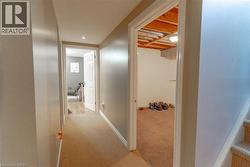 Hallway featuring carpet flooring, recessed lighting, and white baseboards - 
