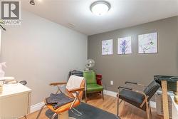 Room with light wood-finish flooring, two-tone walls, recessed lighting, and a semi-flush mount ceiling light - 