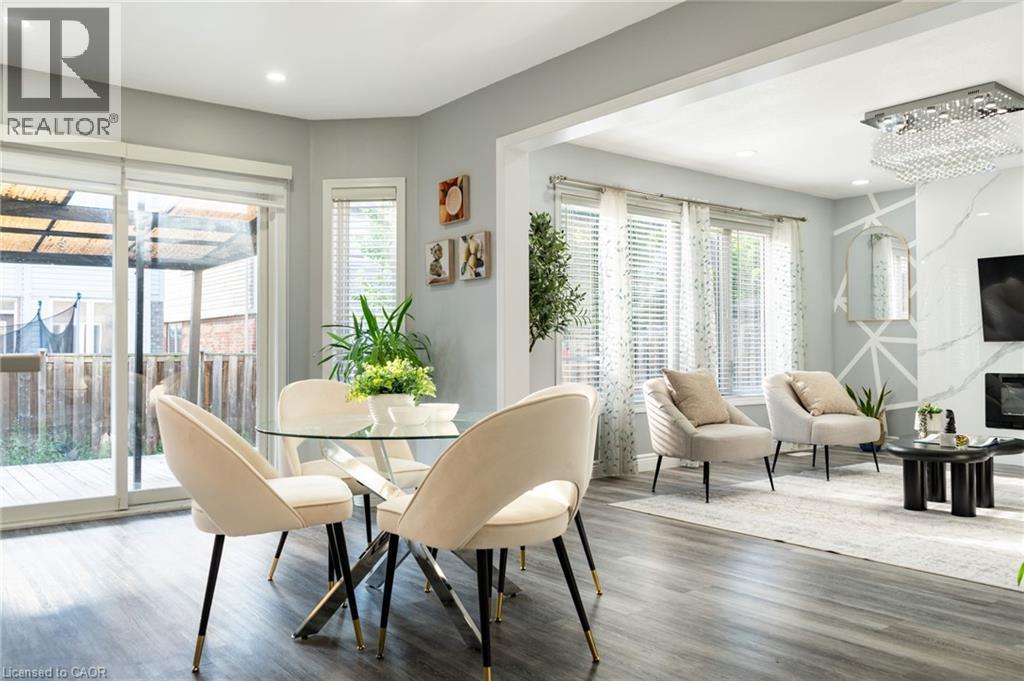 Open-concept living space featuring wood-finish flooring and recessed lighting - 151 Baldwin Drive, Cambridge, ON