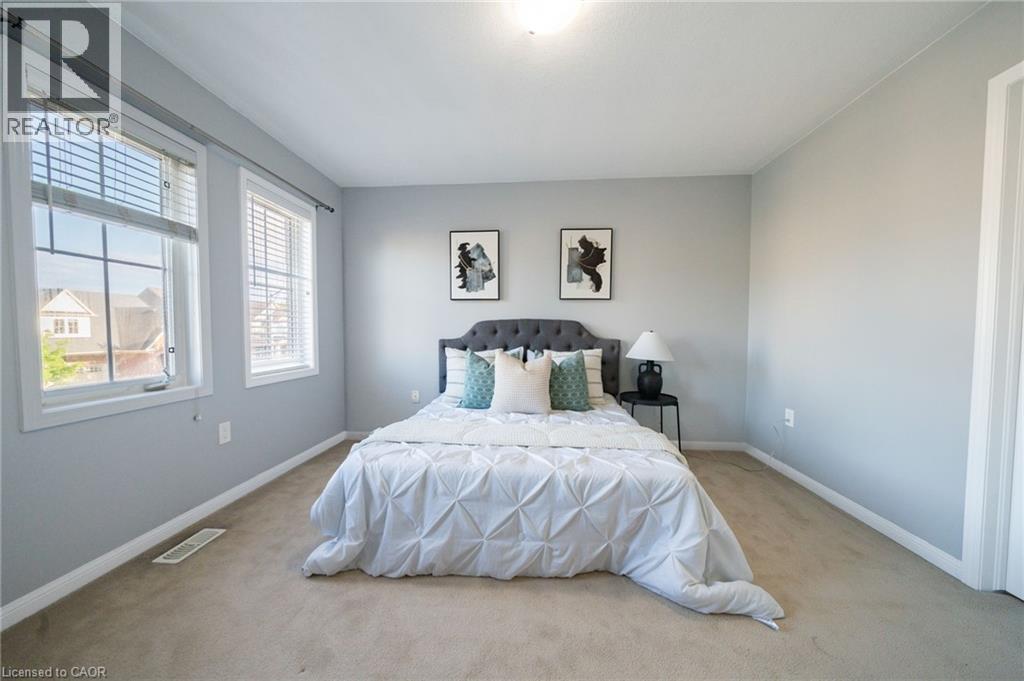 Light gray walls complemented by two large windows with blinds - 151 Baldwin Drive, Cambridge, ON
