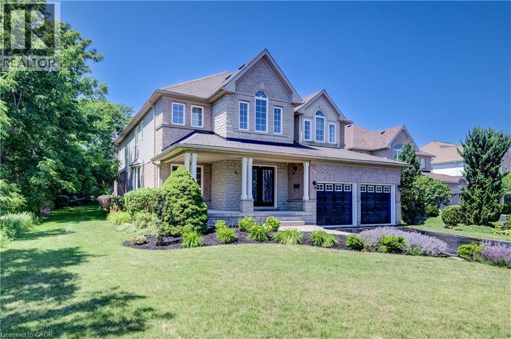 Stone and brick facade residence with a covered porch - 23 Buerkle Court, Kitchener, ON - Outdoor With Facade