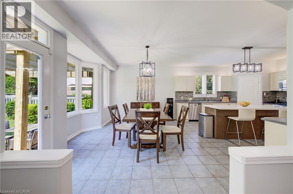 Open-concept living space featuring light gray tile flooring and a bay window - 23 Buerkle Court, Kitchener, ON - Indoor Photo Showing Dining Room