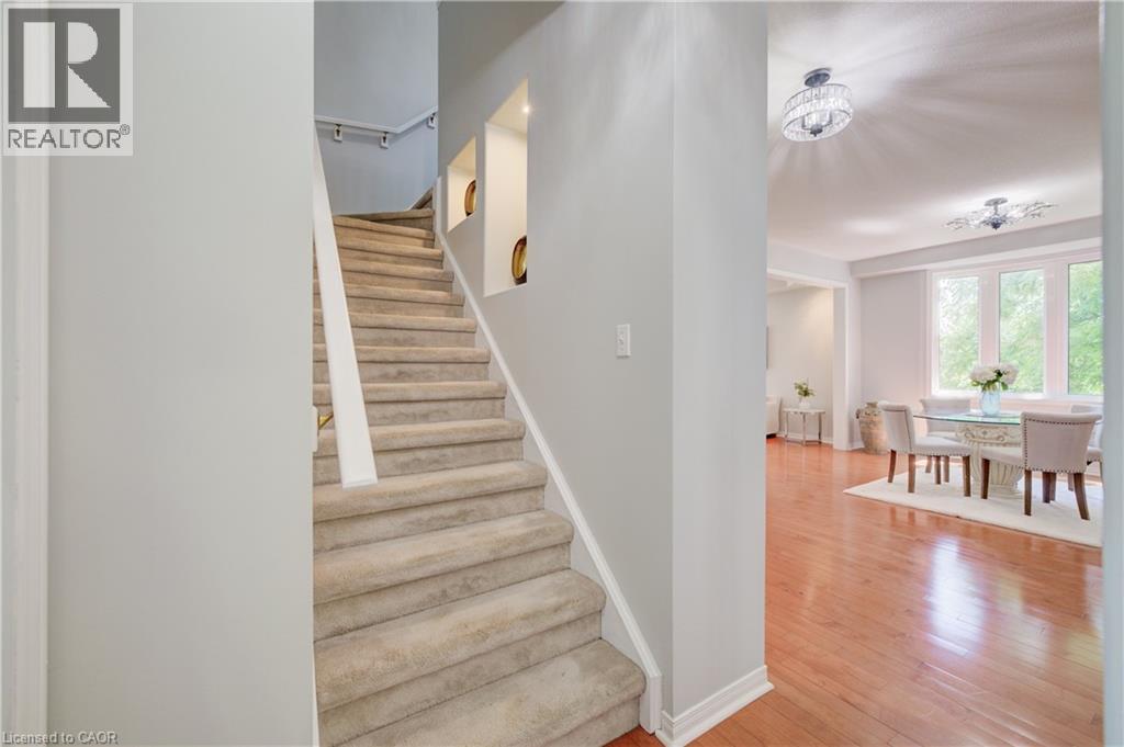 Carpeted staircase with built-in wall niches and a white handrail - 23 Buerkle Court, Kitchener, ON - Indoor