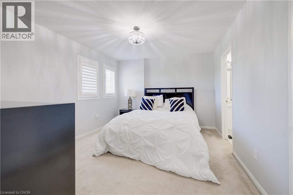 Light-toned carpeting complements the neutral wall finishes - 23 Buerkle Court, Kitchener, ON - Indoor Photo Showing Bedroom