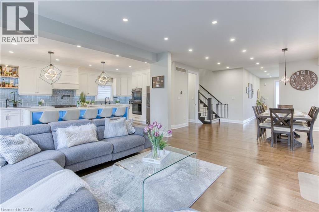Open-concept main living area with wood-finish flooring throughout - 71 Ian Ormston Drive, Waterloo, ON