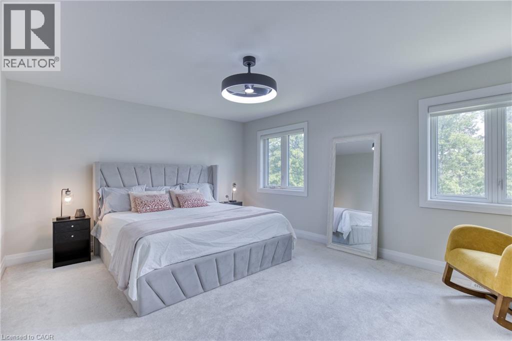 Bright bedroom with plush carpeting and light-toned walls - 71 Ian Ormston Drive, Waterloo, ON