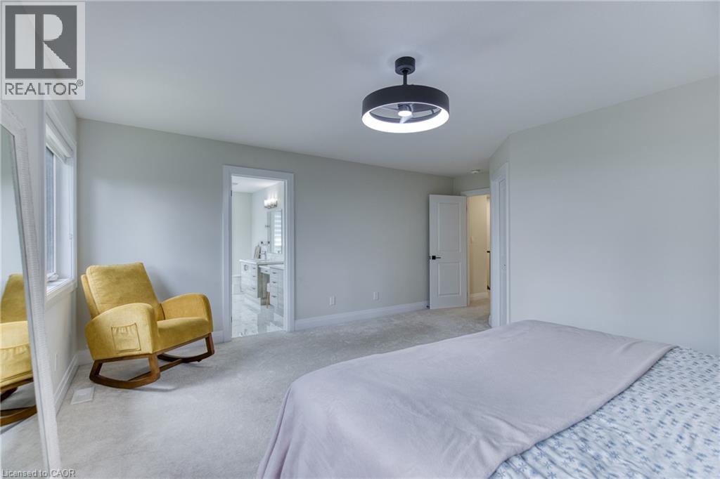 Carpeted room featuring a modern ceiling fan with integrated lighting - 71 Ian Ormston Drive, Waterloo, ON
