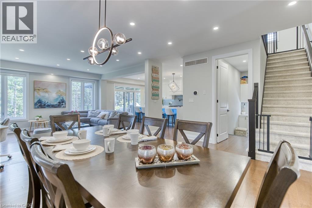 Integrated dining area with hardwood-finish flooring, recessed lighting, and a contemporary chandelier - 71 Ian Ormston Drive, Kitchener, ON - Indoor Photo Showing Dining Room