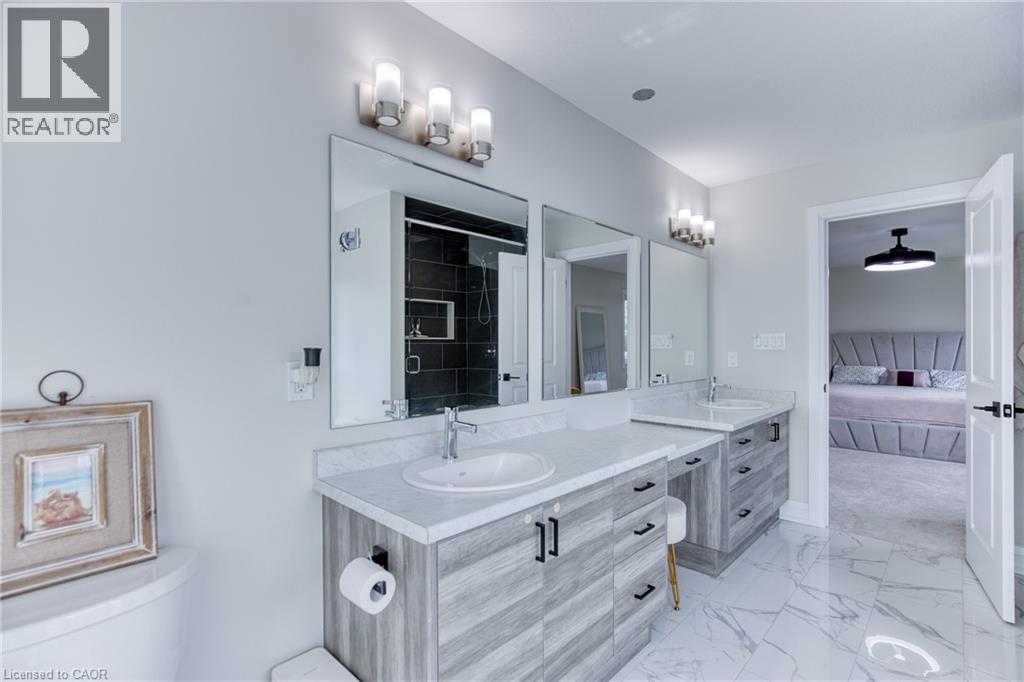 Double vanity with light wood-finish cabinetry and white countertops - 71 Ian Ormston Drive, Kitchener, ON - Indoor Photo Showing Bathroom