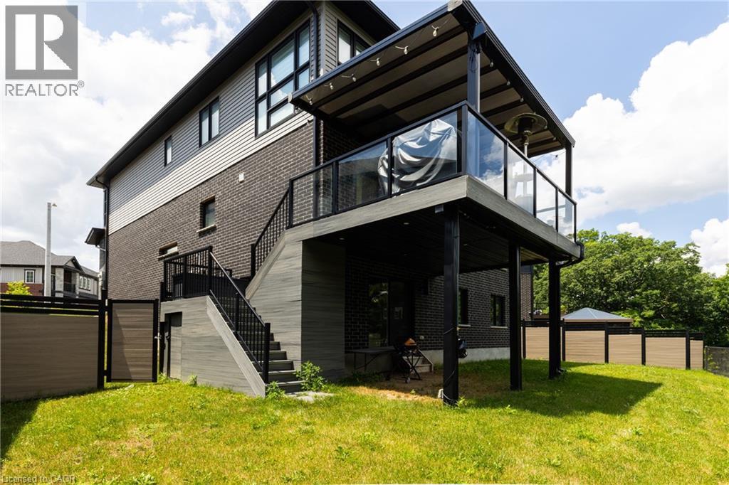 Multi-level exterior featuring dark brick and light-toned horizontal siding - 71 Ian Ormston Drive, Kitchener, ON - Outdoor With Exterior