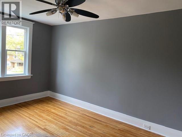 Hardwood flooring, neutral gray wall paint, and white trim - 1066 Richmond Street, London, ON