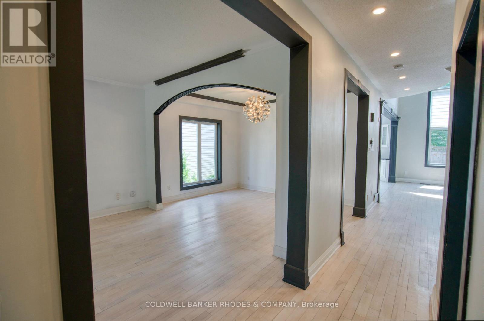 Hallway of the main floor w/living/dining on left - 32 Catterick Crescent, Ottawa, ON