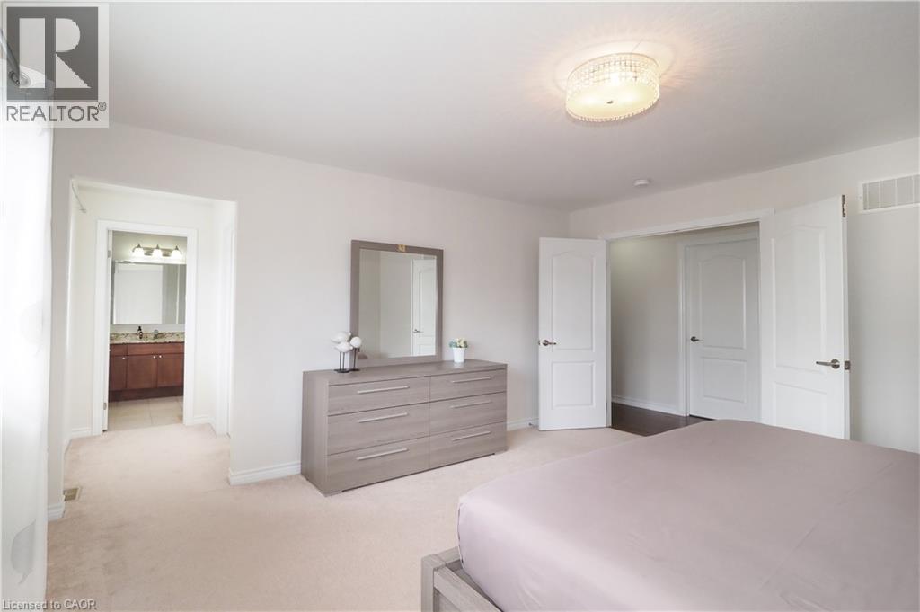 Plush carpeting and light-toned walls define this interior space - 213 Seabrook Drive, Kitchener, ON