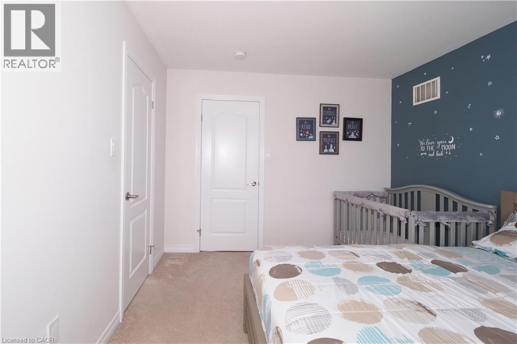 Neutral tone painted walls featuring two panel doors with satin nickel hardware - 213 Seabrook Drive, Kitchener, ON