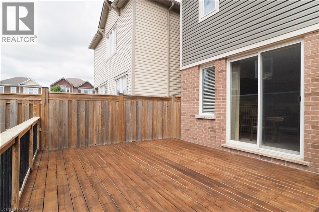 Spacious wood deck with a privacy fence - 213 Seabrook Drive, Kitchener, ON