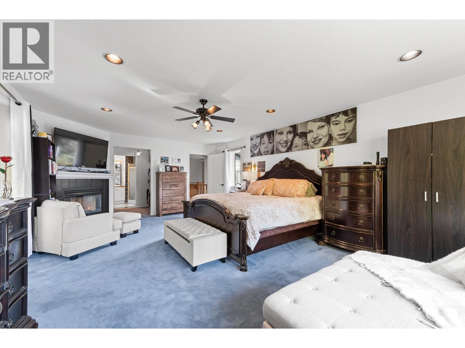 3257 Juniper Drive, Naramata, BC - Indoor Photo Showing Bedroom With Fireplace
