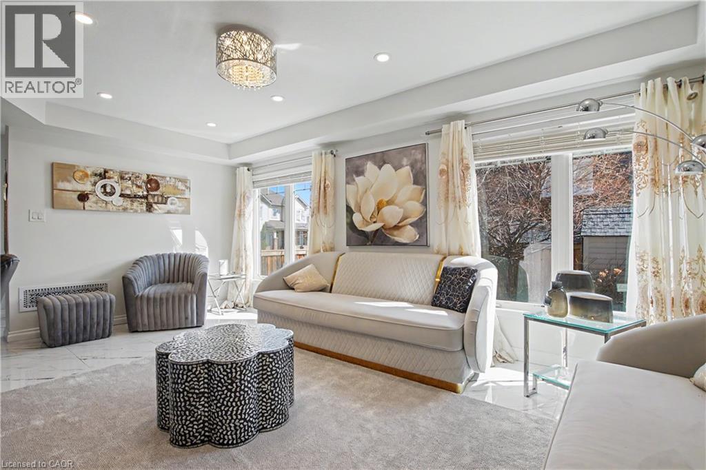 Living area featuring recessed lighting, a decorative ceiling fixture, and tray ceilings - 60 Postmaster Drive, Kitchener, ON - Indoor Photo Showing Living Room