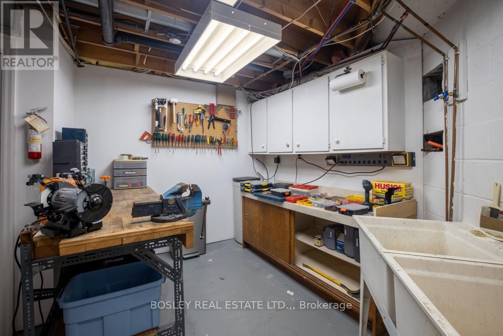 workshop and utility room - 720 Lake Street, St. Catharines (Lakeshore), ON - Indoor Photo Showing Basement With Fireplace