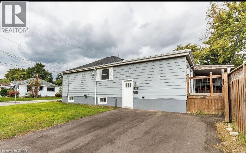 Light blue horizontal siding exterior with a white entry door - 63 Audrey Street, Hamilton, ON - Outdoor