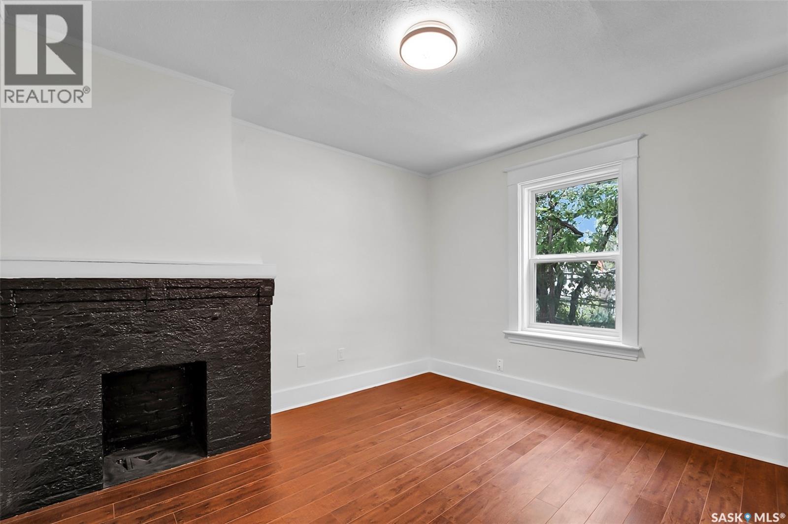 736 7Th Avenue N, Saskatoon, SK - Indoor Photo Showing Other Room With Fireplace