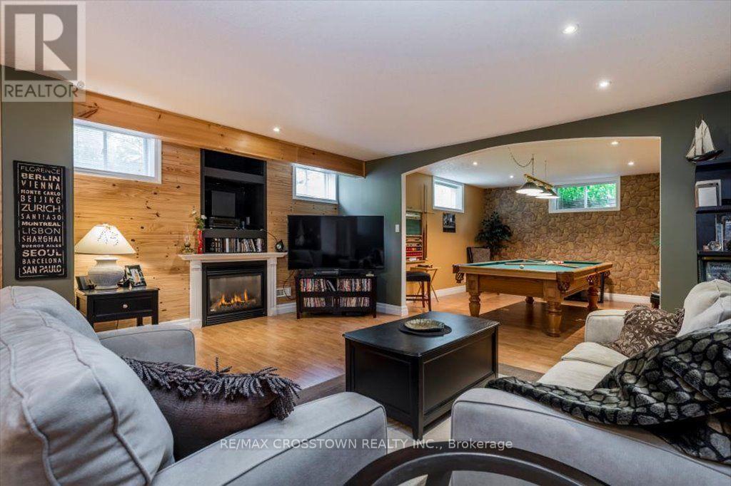 Lower level recreation area - 5 Pine Hill Drive, Springwater, ON - Indoor Photo Showing Living Room With Fireplace