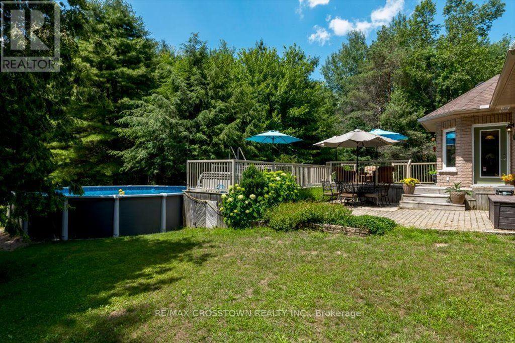 Rear yard - 5 Pine Hill Drive, Springwater, ON - Outdoor With Above Ground Pool