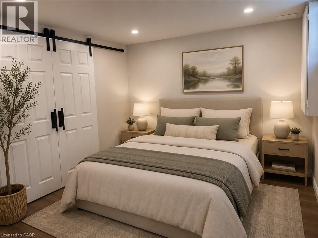 Bedroom featuring a barn door closet with black hardware, recessed lighting, and wood-finish flooring - 4187 Weimar Line, Wellesley, ON - Indoor Photo Showing Bedroom