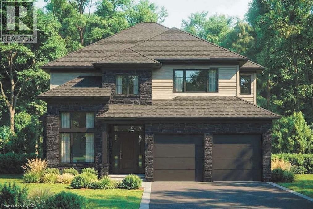 Contemporary residence featuring a prominent gabled roofline, stone facade elements, neutral-toned siding, and a two-car garage with dark paneled doors - 4239 Fly Road, Campden, ON - Outdoor With Facade