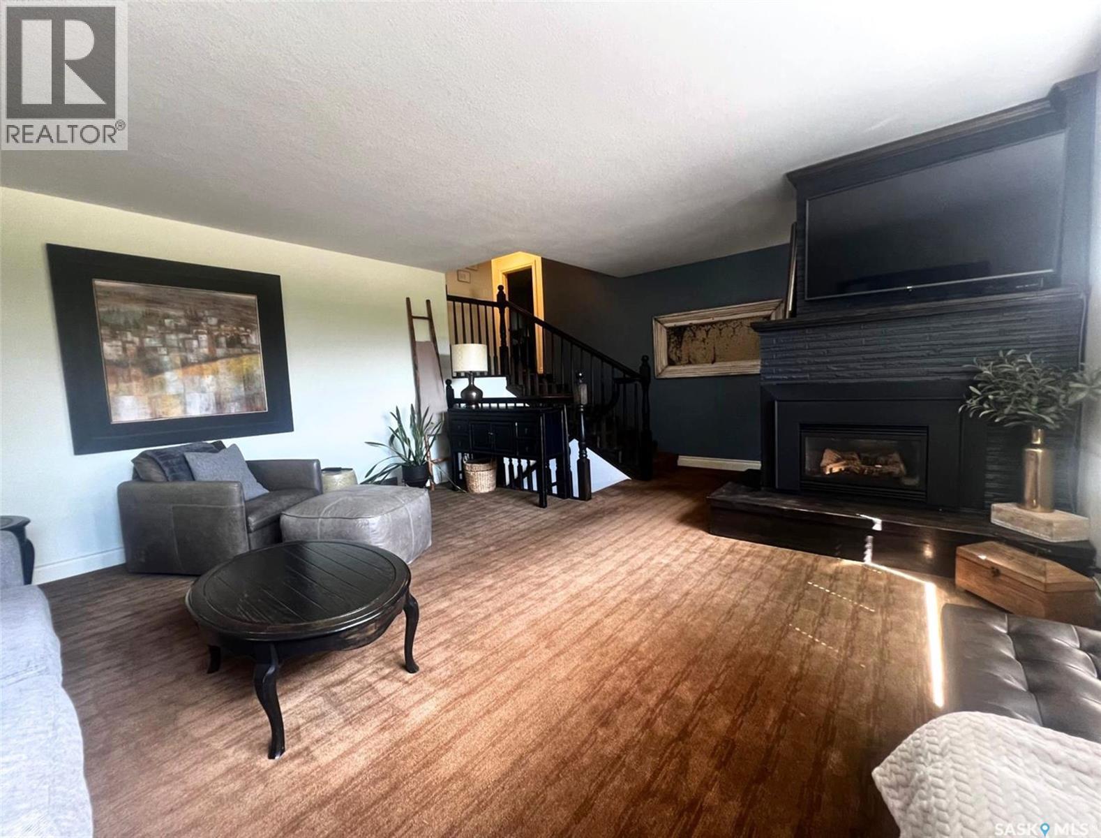1183 George Street E, Swift Current, SK - Indoor Photo Showing Living Room With Fireplace