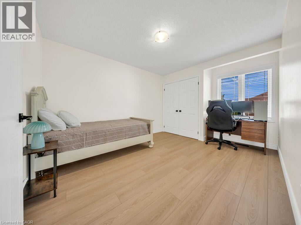 Light wood-finish flooring complements the neutral wall color of this room - 39 Baintree Way, Cambridge, ON - Indoor