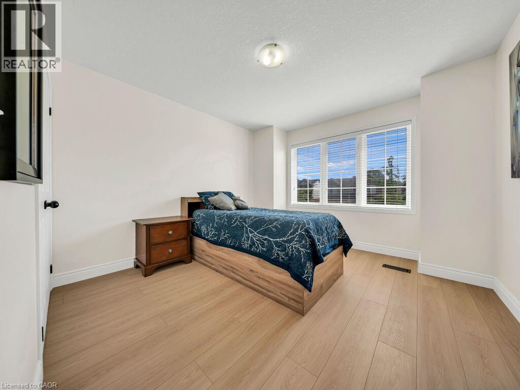 Bright room featuring light wood-finish flooring and white baseboards - 39 Baintree Way, Cambridge, ON - Indoor Photo Showing Bedroom