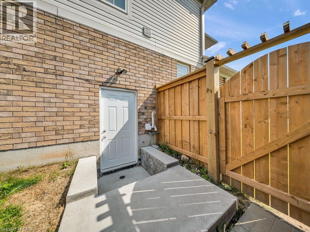 Exterior featuring light brown brick masonry and white vinyl siding - 39 Baintree Way, Cambridge, ON - Outdoor With Exterior