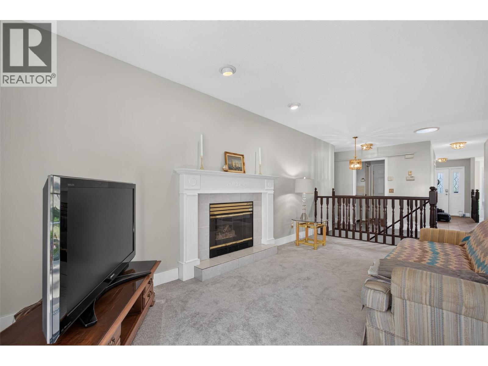 Family room - 602 Glenmeadows Road, Kelowna, BC - Indoor Photo Showing Living Room With Fireplace